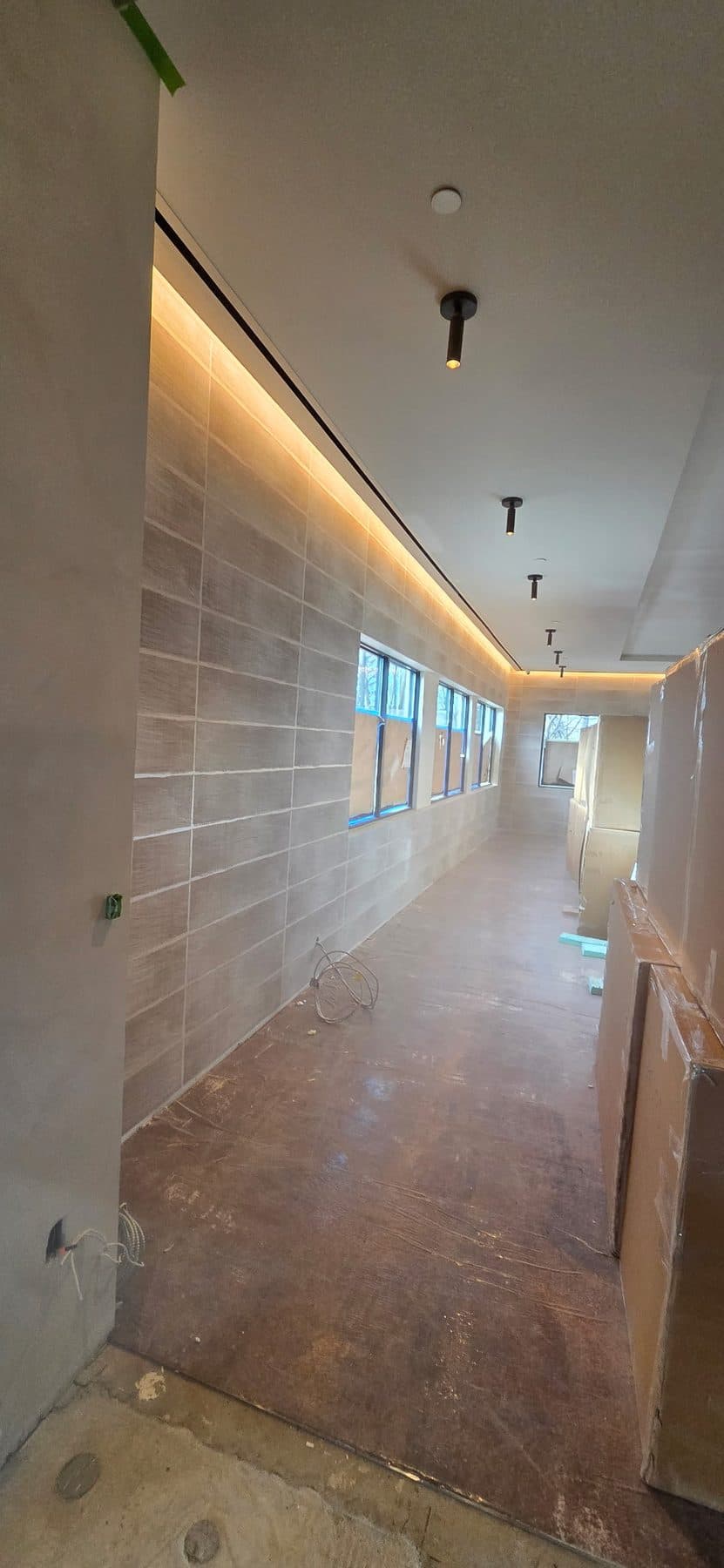 Warm woodgrain wallcovering along a corridor