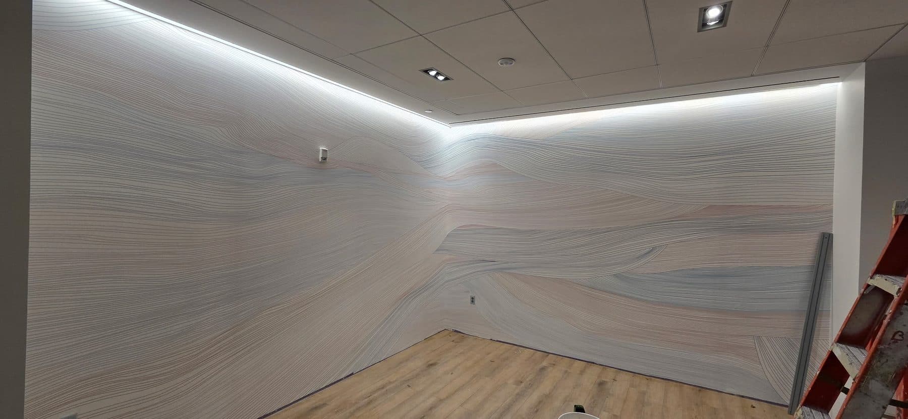 Book-matched stone-effect panels in a cove-lit lounge