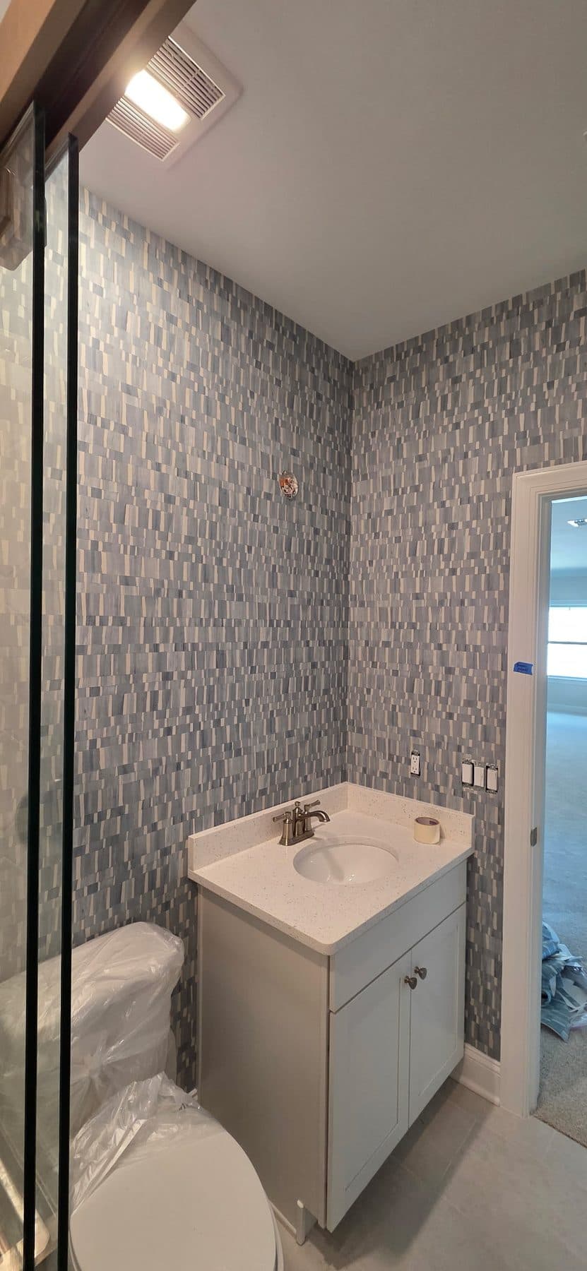 Silver-ground wallcovering in a powder room